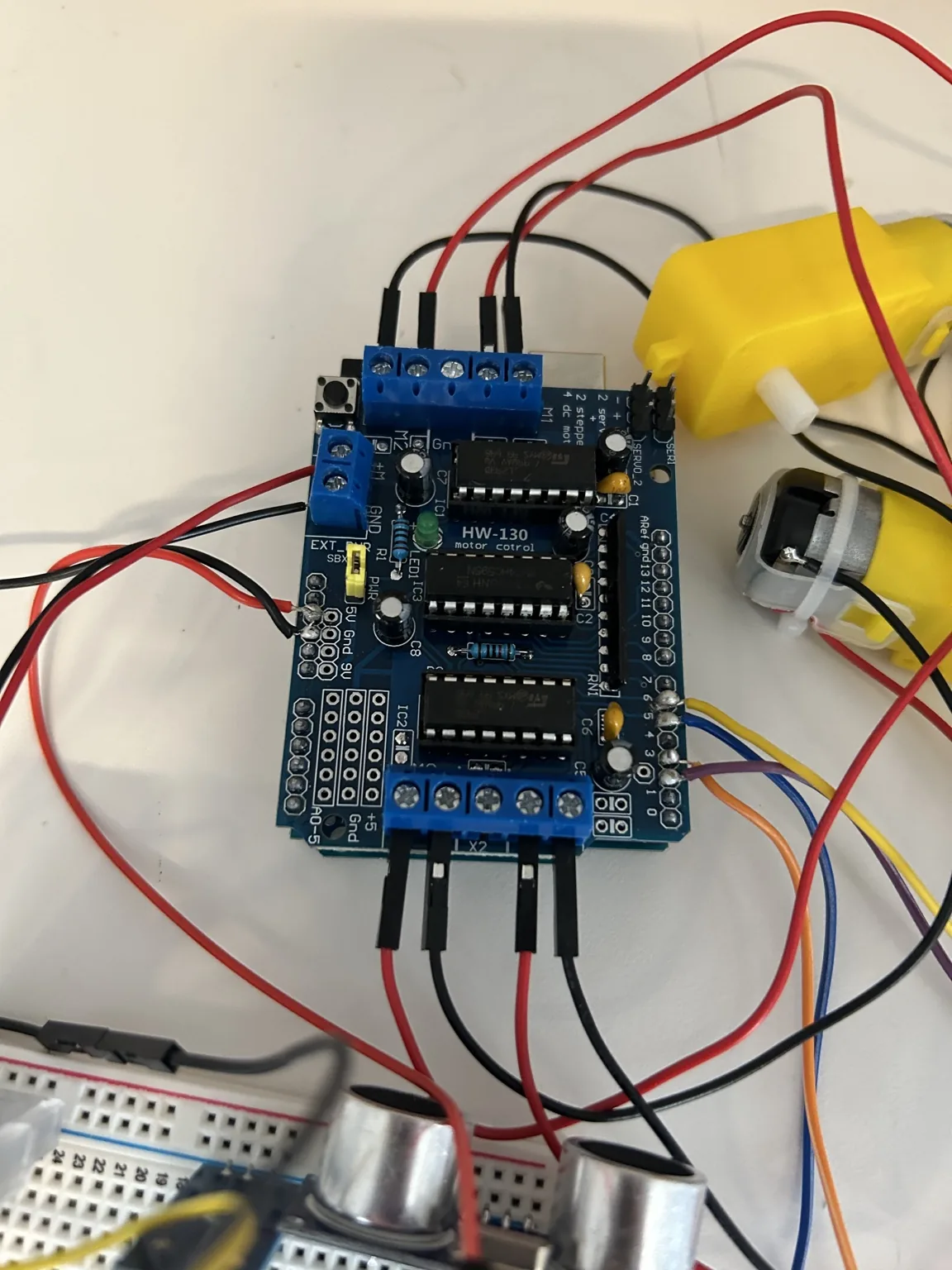 Close-up of the HW-130 motor-control board with motor leads and signal wiring