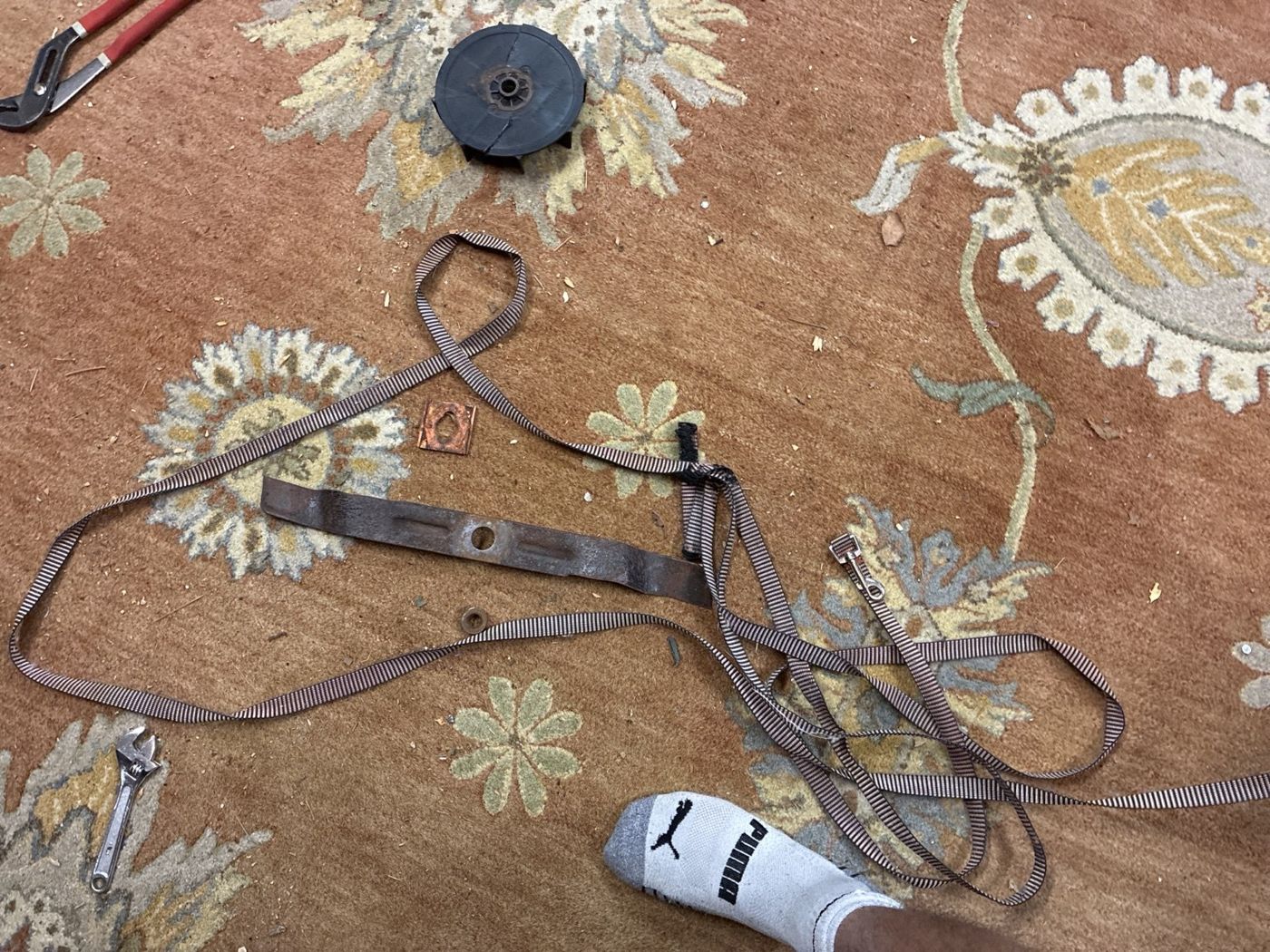 Removed mower housing components and hardware laid out during teardown