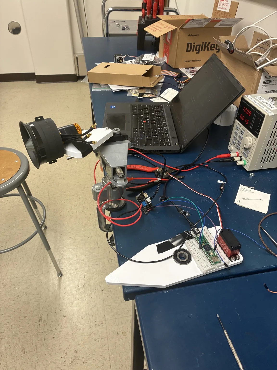Servo and EDF gimbal bench setup connected to a microcontroller and bench power supply